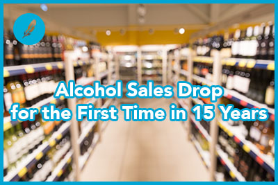 sale, shopping, consumerism and alcohol concept - liquor store blurred out of focus background with bokeh