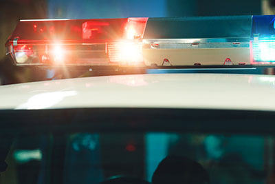 Police light and siren on the car in action.