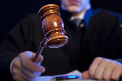 Judge. Male judge in a courtroom striking the gavel